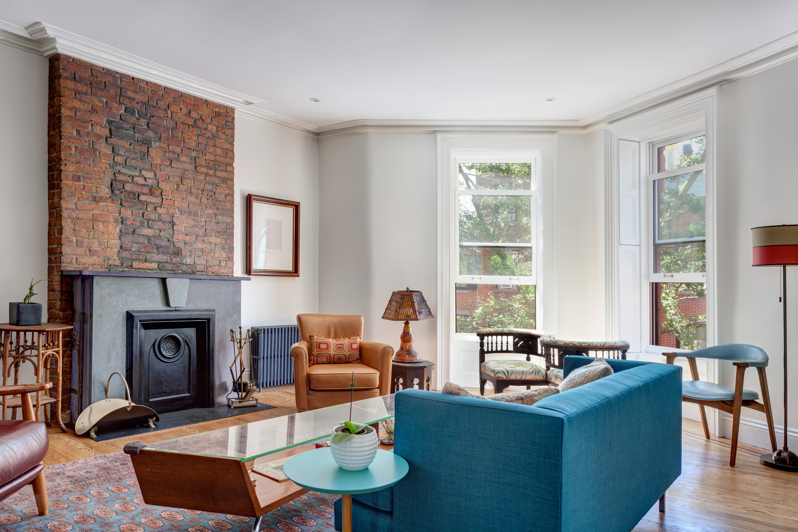 Living room with new fireplace and furnishings at the front of a Brooklyn Heights apartment after our renovation.