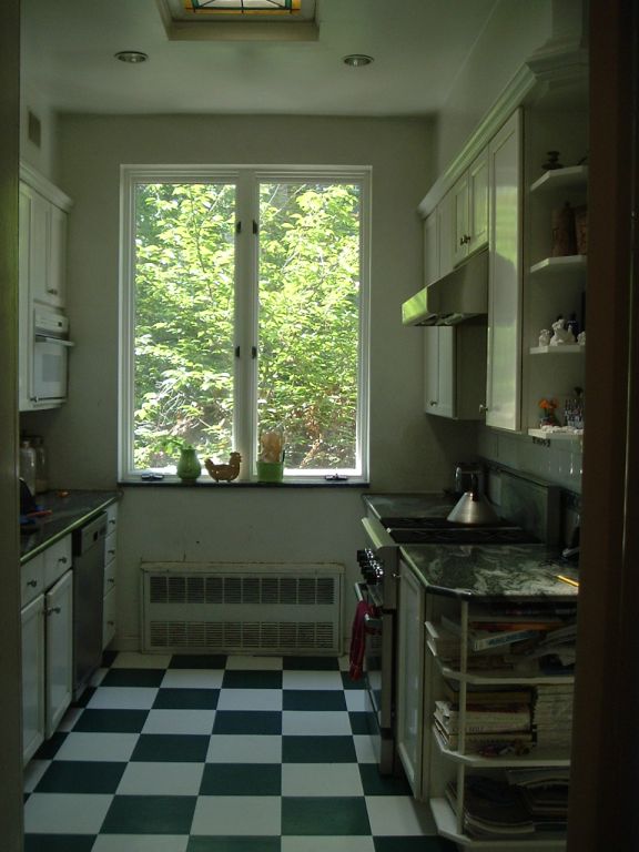 Kitchen in a Brooklyn Heights apartment with black and white floor tiles.