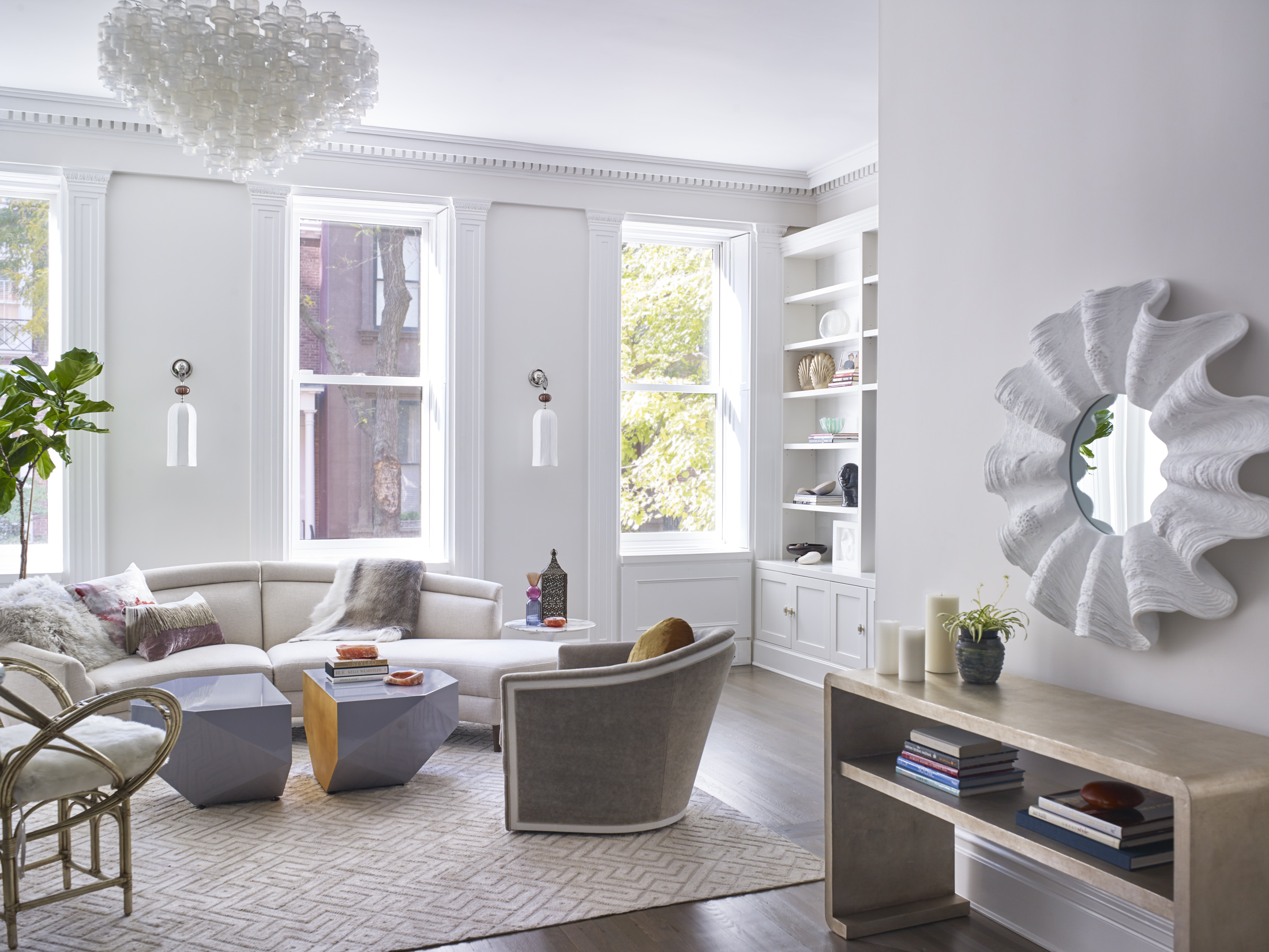 Living room with preserved historic details, white walls, and eclectic modern furnishings.