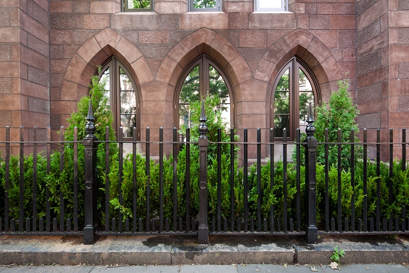 Exterior of a Brooklyn church after our renovation, with a restored fence and brownstone façade
