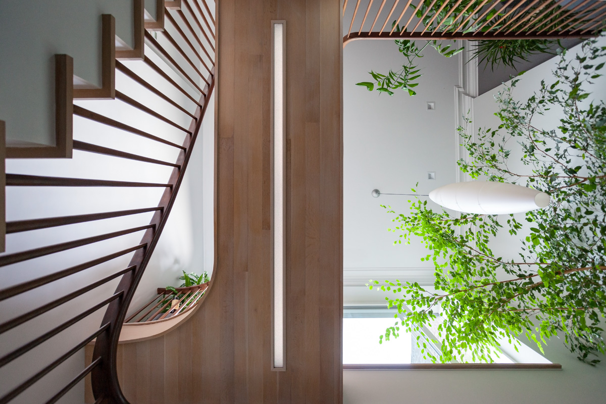 View of an elevated walkway from below with a long flushmount light underneath